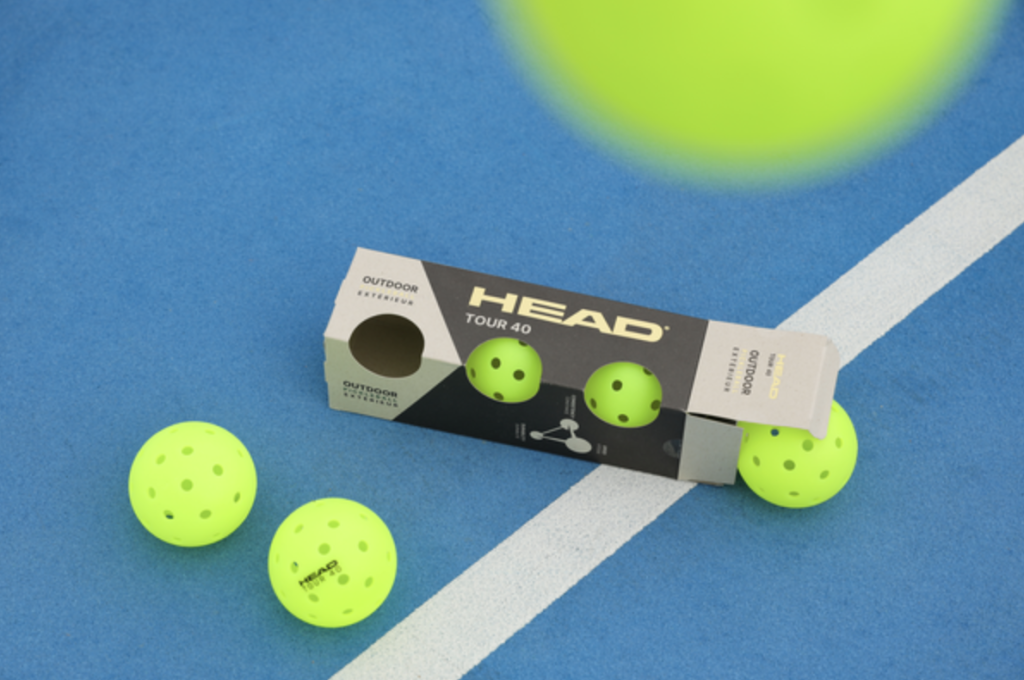 pickleball racquets and balls on a court